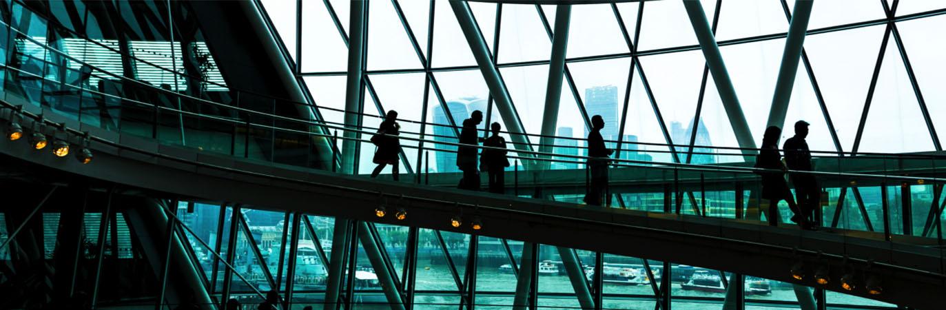 Interior of an office building with investment professionals walking