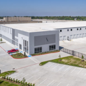 White and grey industrial building facade and parking lot